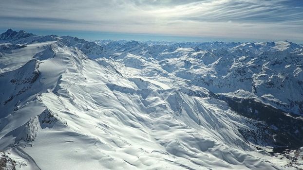 Amazing view from a drone over the snowy mountain hills