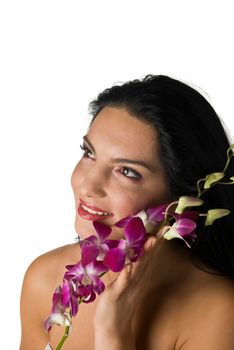 Woman with orchid looking away on white background