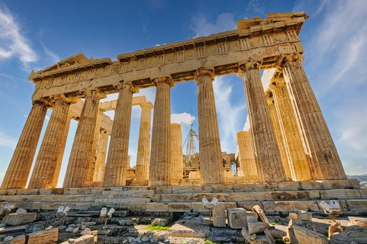 The Acropolis of Athens, Greece, with the Parthenon Temple on top of the hill during a summer sunset..