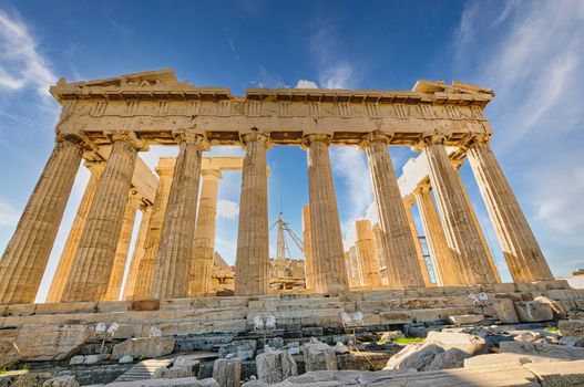 The Acropolis of Athens, Greece, with the Parthenon Temple on top of the hill during a summer sunset..