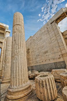 Athens Acropolis, Greece landmark. Ancient Greek Propylaea entrance gate ceiling and pillars low angle view, blue sky, spring sunny day.