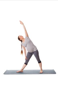 Pregnancy yoga exercise - pregnant woman doing asana Utthita trikonasana - extended triangle pose easy variation isolated on white background