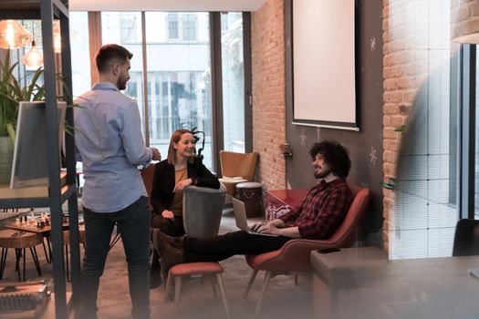 Successful team. Group of young businesspeople working and communicating together in creative office. Selective focus. High-quality photo