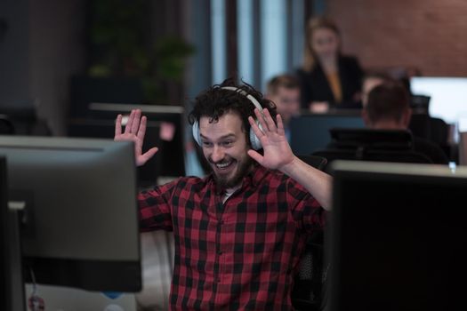 Funny businessman wearing headset having virtual team meeting group call chatting with diverse people in customer support. Video conference call on a computer with manager and employees. High-quality photo