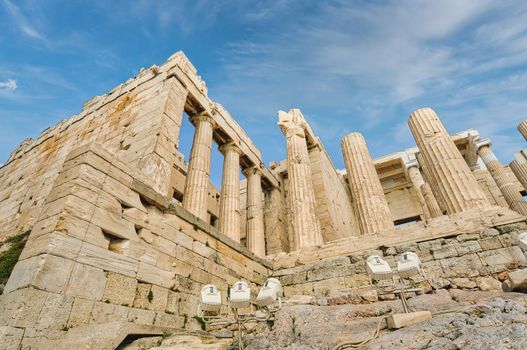 Athens Acropolis, Greece landmark. Ancient Greek Propylaea entrance gate ceiling and pillars low angle view, blue sky, spring sunny day.