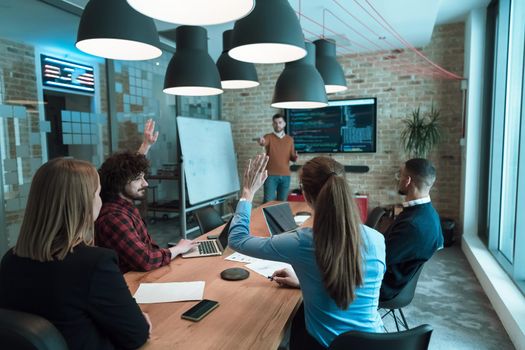 Leader give a business presentation at an office conference meeting, businessman coach mentor explains graph chart on board corporate group workshop training in the boardroom. Selective focus. High-quality photo