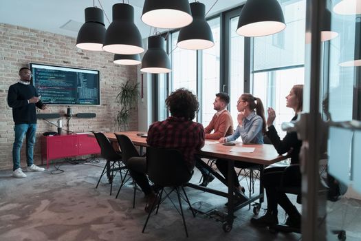 Leader give a business presentation at an office conference meeting, businessman coach mentor explains graph chart on board corporate group workshop training in the boardroom. Selective focus. High-quality photo