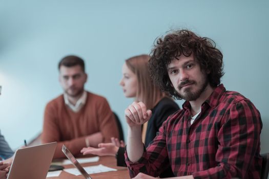 Successful team. Group of young multi-ethnic business people working and communicating together in creative office. Selective focus. High-quality photo