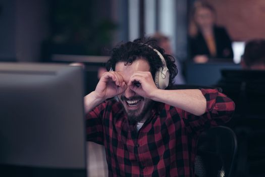 Funny businessman wearing headset having virtual team meeting group call chatting with diverse people in customer support. Video conference call on a computer with manager and employees. High-quality photo