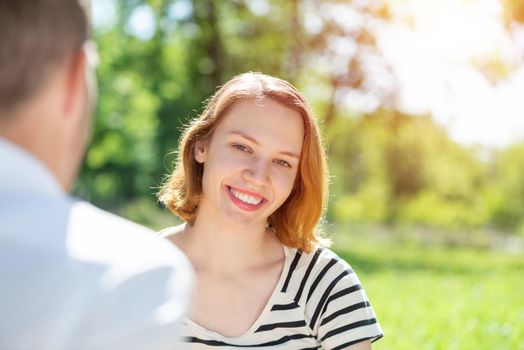 Portrait of a young attractive woman on a date in a park. Spending time with loved ones