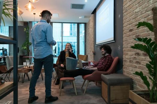 Successful team. Group of young businesspeople working and communicating together in creative office. Selective focus. High-quality photo