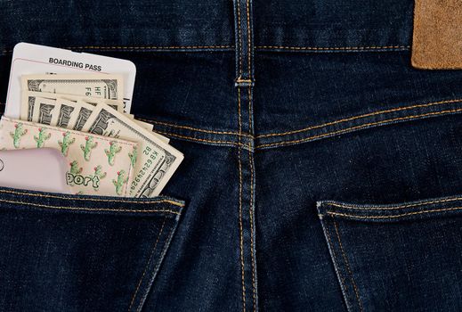 Dollars, smart and plane ticket in your pocket jeans. Top view. Copy space. Still life. Flat lay