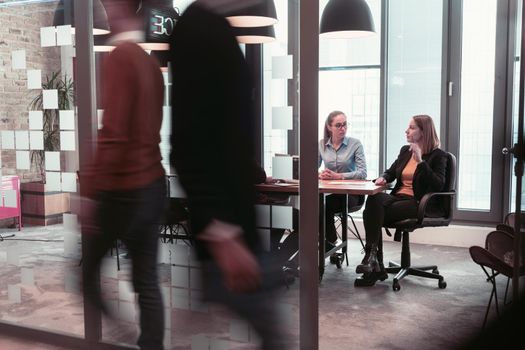 Successful team. Group of young business people working and communicating together in creative office. Selective focus. High-quality photo