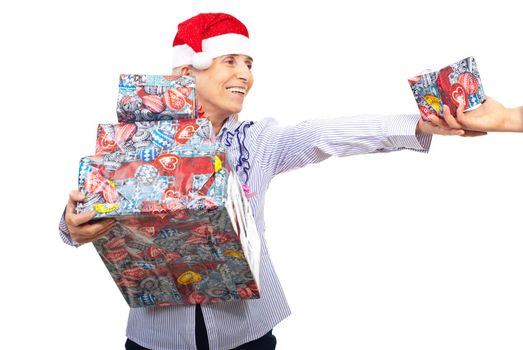 Senior woman holding stack of Christmas presents and extends her hand to take a smaller gift box  from someone isolated on white background