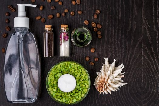 soaps, bath salt, mask on wood table background. spa. top view. still life