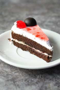 chocolate and cream cake on a plate on table .