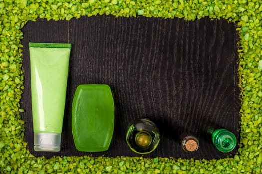 Cosmetic hygienic products on wooden background. Frame of salt. Still life. Top view. Copy space