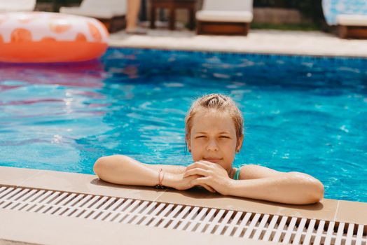 Happy child having fun on summer vacation. Kid playing with rubber duck and ball in the sea. Healthy lifestyle concept. Happy child playing in swimming pool. Summer vacations concept