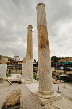 Library of Hadrian, Athens, Greece. It is one of the main tourist attractions of Athens. Scenic panorama of ancient Greek ruins in Athens center in summer. Acropolis of Athens in the distance.