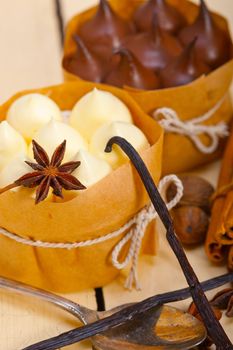 fresh baked chocolate vanilla and spices cream cake dessert over rustic wood table 