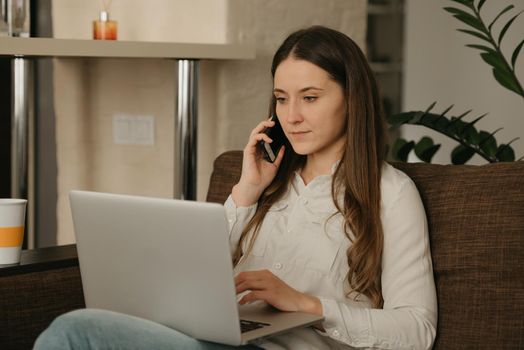 Remote work. A caucasian woman studying remotely on her laptop. A lady with long hair calling from home.