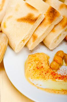 traditional chickpeas Hummus with pita bread and paprika on top 