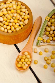 organic soya beans over rustic wood table macro closeup