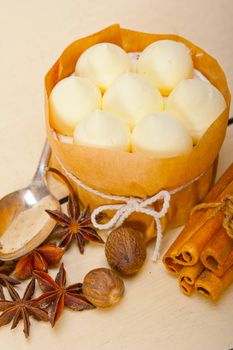 fresh vanilla and spice cream cake dessert over a rustic white wood table