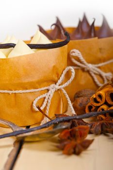 fresh baked chocolate vanilla and spices cream cake dessert over rustic wood table 