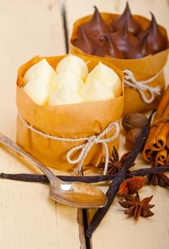 fresh baked chocolate vanilla and spices cream cake dessert over rustic wood table 