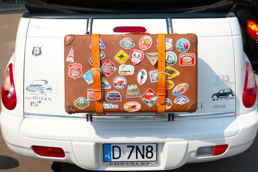 Wroclaw, Poland, August 22, 2021: Beautiful leather suitcase on the car with stickers. Travelling by car