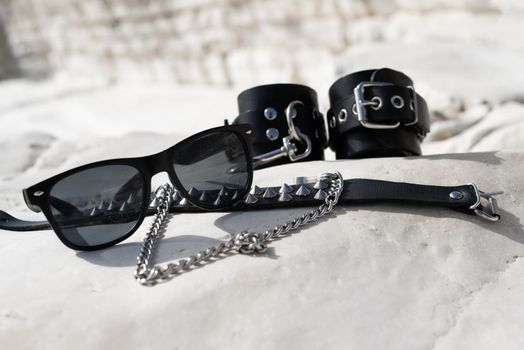 the leather handcuffs for bdsm sex toys on the beach while on vacation in summer