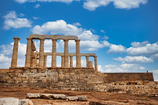 Greece. Cape Sounion - Ruins of an ancient Greek temple of Poseidon before sunset under dramatic cloudy sky