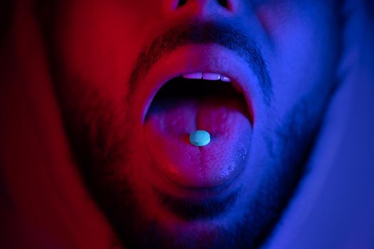 Close up of man mouth swallowing ecstasy drugs. Man taking MDMA ecstasy pill. High quality 4k footage