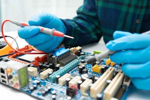 Asian Technician repairing micro circuit main board computer electronic technology, hardware, mobile phone, upgrade, cleaning concept.