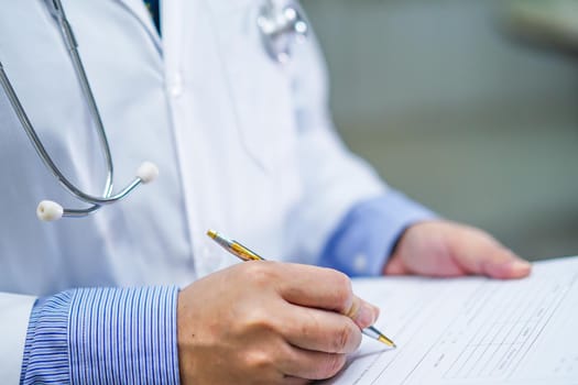 Doctor writing down the diagnosis on clipboard while Asian senior or elderly old lady woman lying on bed in nursing hospital ward : healthy strong medical concept.