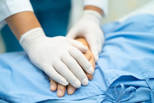 Touching hands Asian senior or elderly old lady woman patient with love, care, helping, encourage and empathy at nursing hospital ward