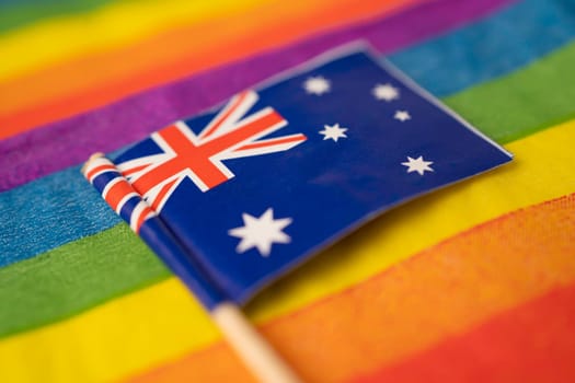 Australia flag on rainbow background symbol of LGBT gay pride month social movement rainbow flag is a symbol of lesbian, gay, bisexual, transgender, human rights, tolerance and peace.