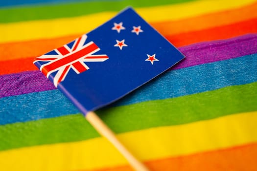 New Zealand flag on rainbow background symbol of LGBT gay pride month social movement rainbow flag is a symbol of lesbian, gay, bisexual, transgender, human rights, tolerance and peace.