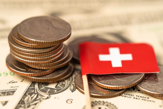 Stack of coins with Switzerland flag on USA America dollar banknotes.