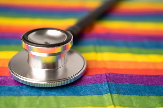 Black stethoscope on rainbow background, symbol of LGBT pride month celebrate annual in June social, symbol of gay, lesbian, gay, bisexual, transgender, human rights and peace.