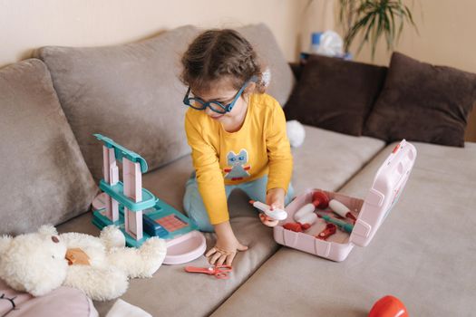 Happy adorable girl playing doctor