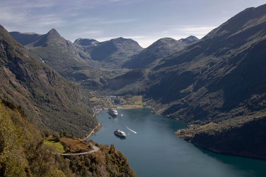 Beautiful landscape showing some boats on a norwegian fjord and some mountains