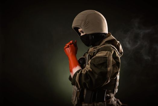 girl soldier with bloodied hands wearing a helmet and a bulletproof vest