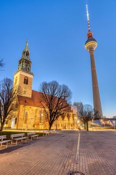 The famous TV Tower and the St. Mary's Church at the Alexanderplatz in Berlin at dawn