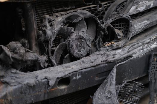 Burnt car after accident or short circuit of car wiring. Insurance compensation after car arson concept