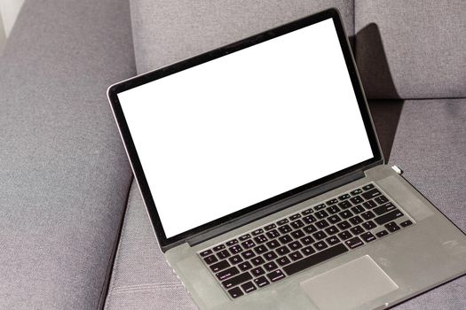 Mockup blank screen laptop on couch in living room