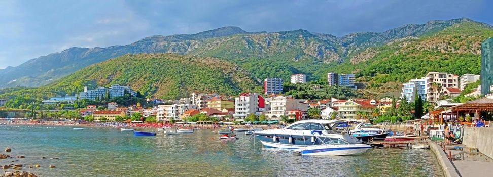 Resort town on the coast of Montenegro. Cove with boats on the Adriatic Sea, a small tourist town with beaches. Tourist trips, swimming in the sea with boats and buoys. Sanatoria casino and bouzas img
