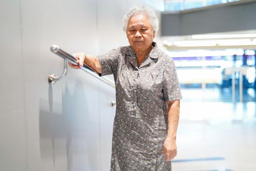 Asian senior or elderly old lady woman patient use slope walkway handle security with help support assistant in nursing hospital ward : healthy strong medical concept.