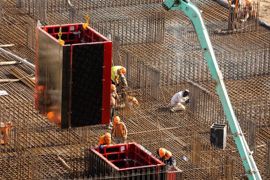 workers working with concrete irons in a construction site.